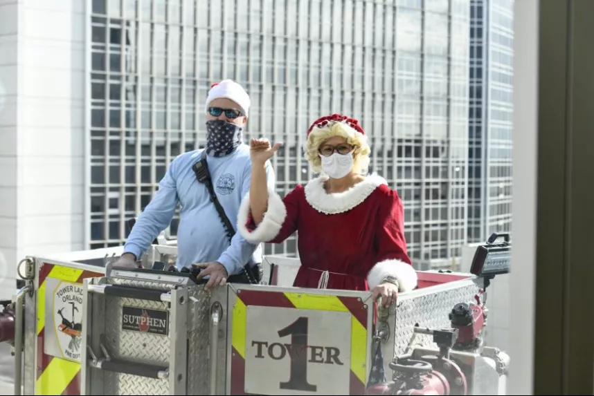 Mrs. Claus and a friend from Orlando Fire Department spread joy at AdventHealth for Children.