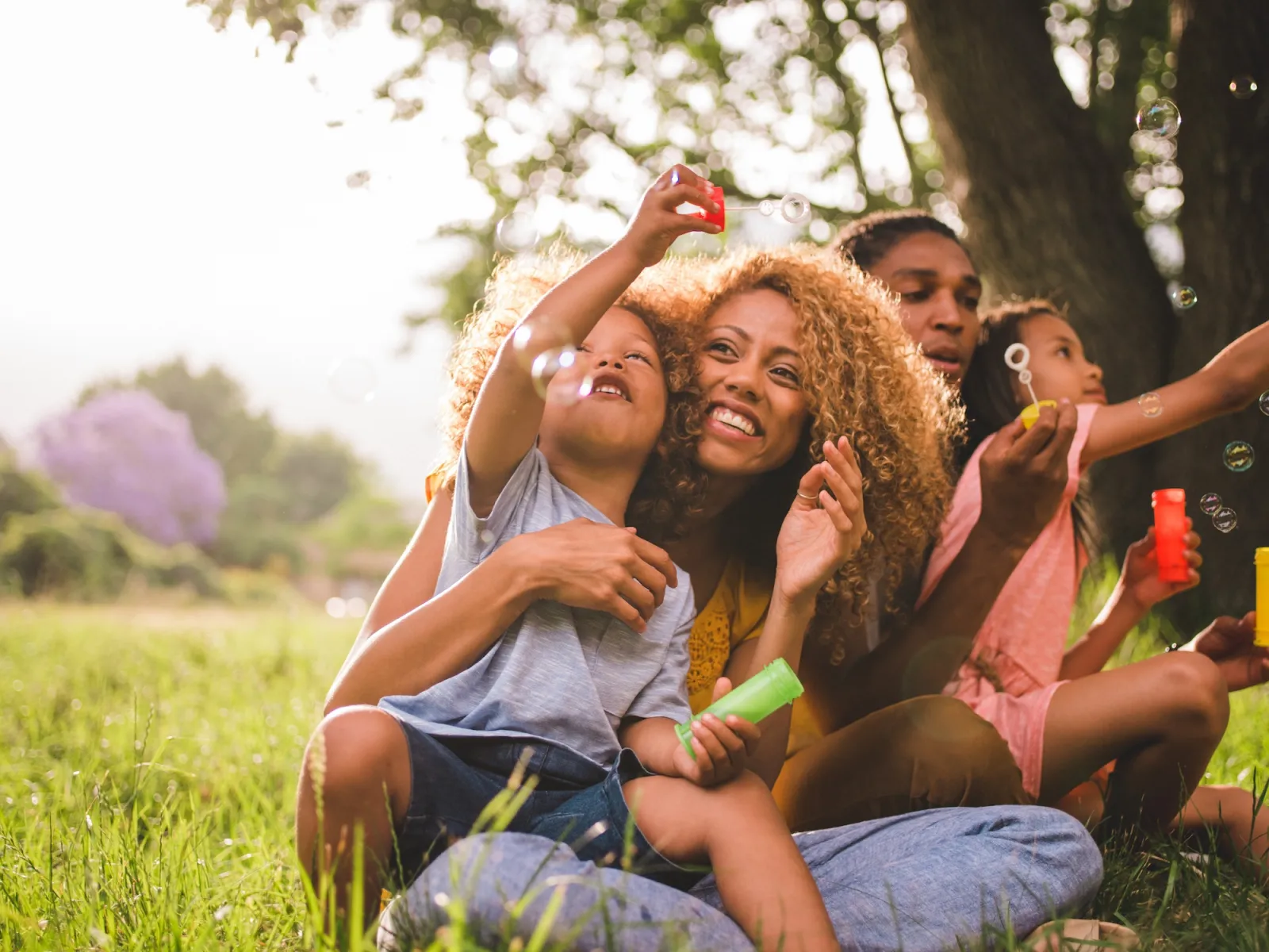 A family blowing bubbles together outdoors