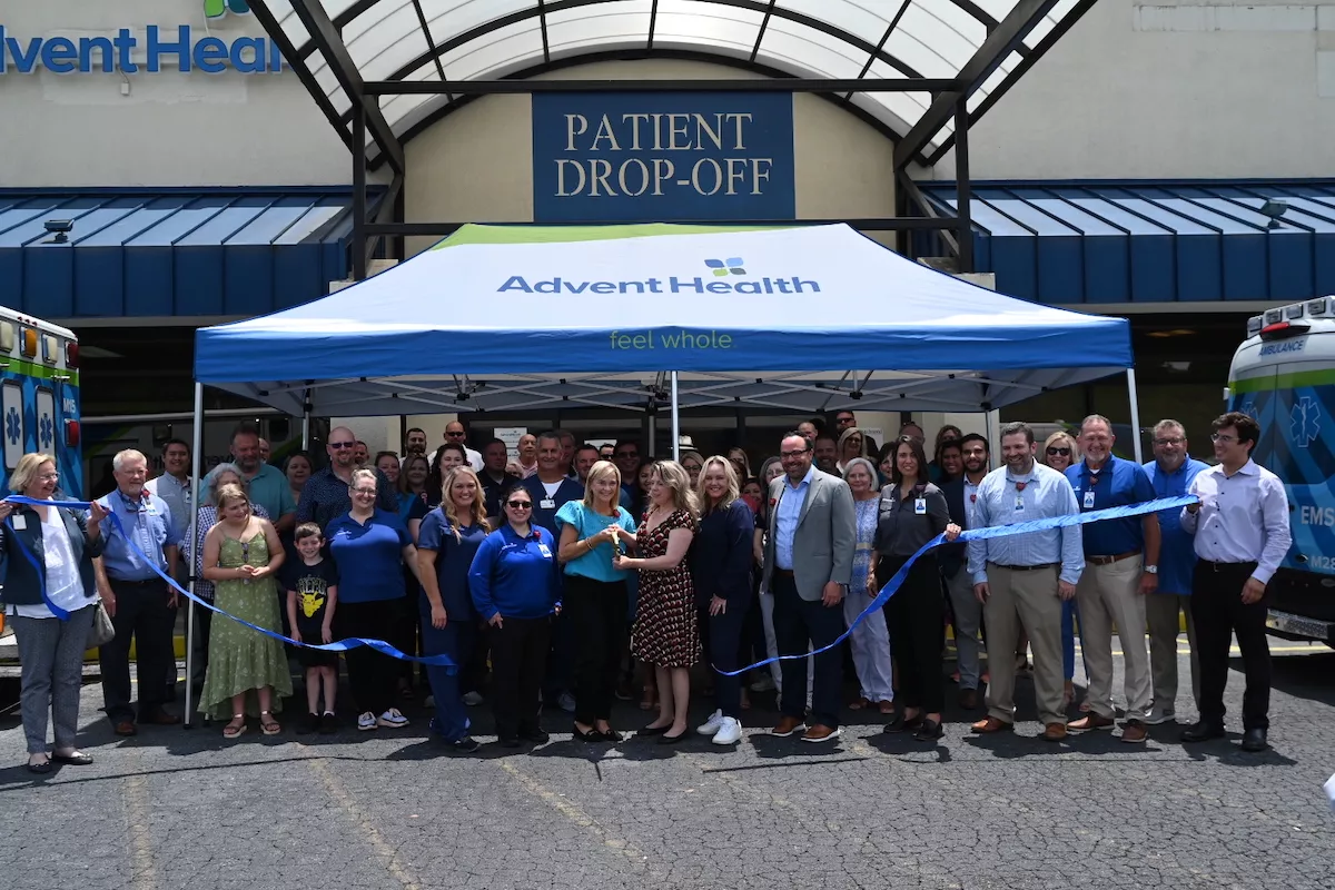 a group gathers to cut the ribbon to celebrate cedartown clinic opening