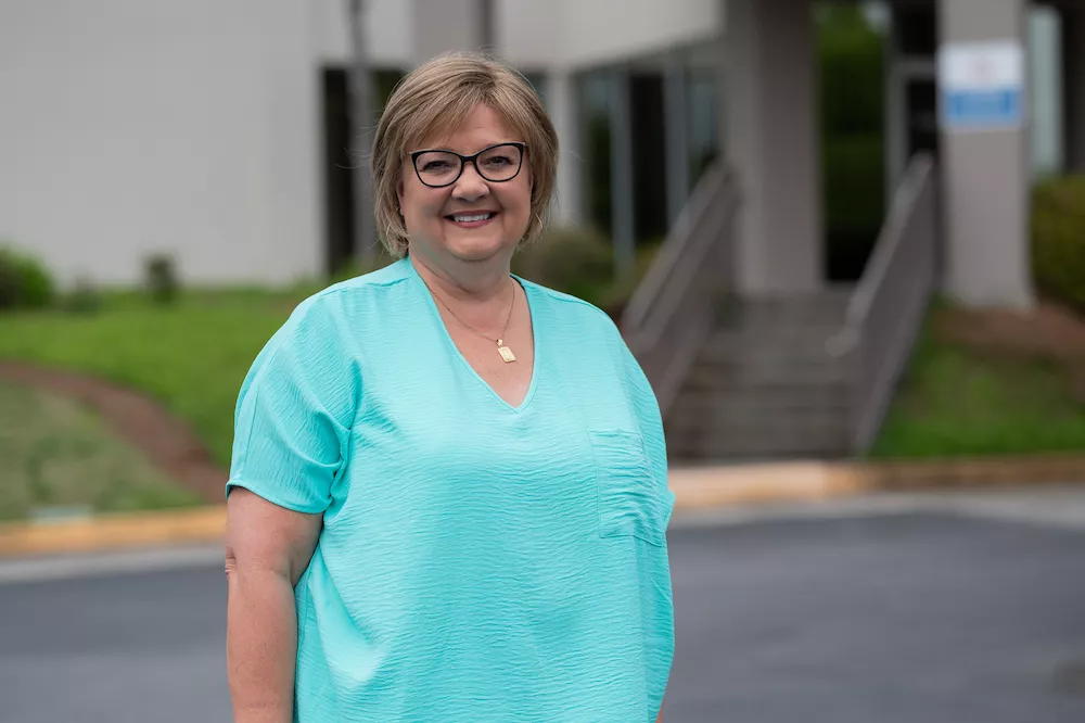 Woman smiles in front of the Women's Center