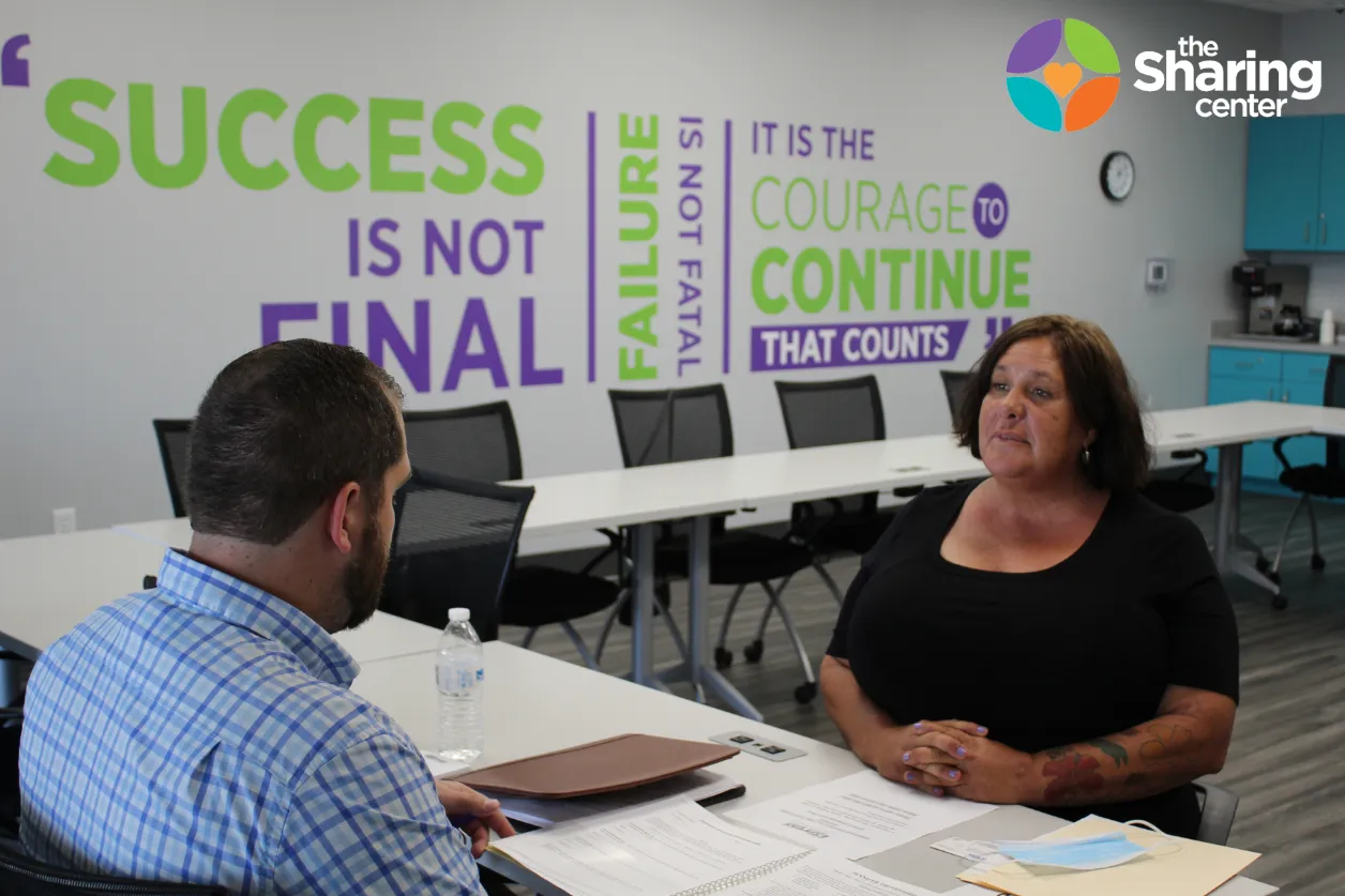 A client at The Sharing Center practices her interviewing skills during a mock job interview.