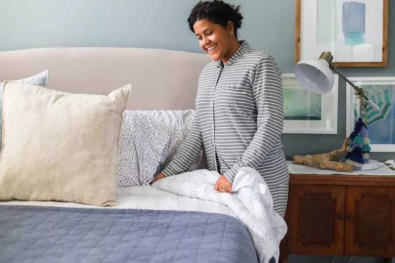 Woman making bed